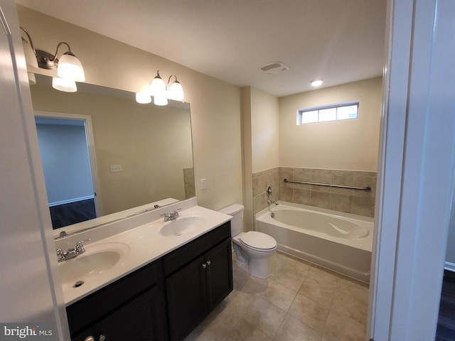 bathroom featuring vanity, an inviting chandelier, tile patterned floors, toilet, and a tub