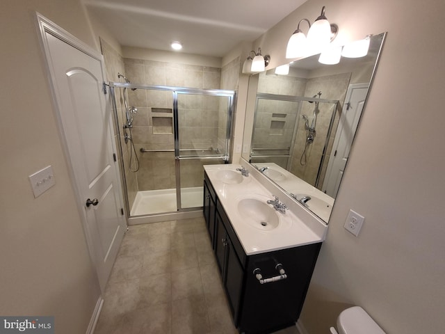 bathroom featuring vanity, tile patterned floors, and a shower with shower door