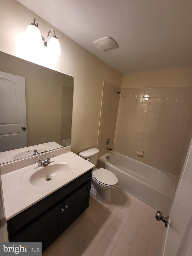 full bathroom featuring toilet, vanity, tile patterned floors, and tiled shower / bath