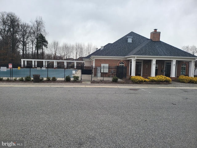 view of building exterior featuring a covered pool