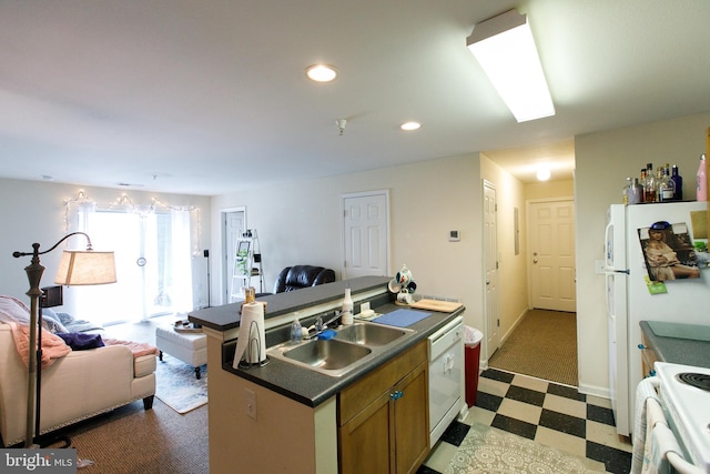 kitchen featuring a center island with sink, white appliances, and sink