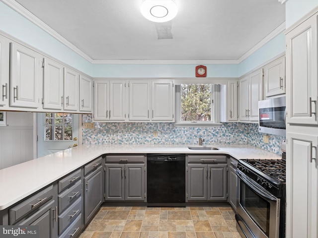 kitchen featuring gray cabinets, kitchen peninsula, sink, and appliances with stainless steel finishes