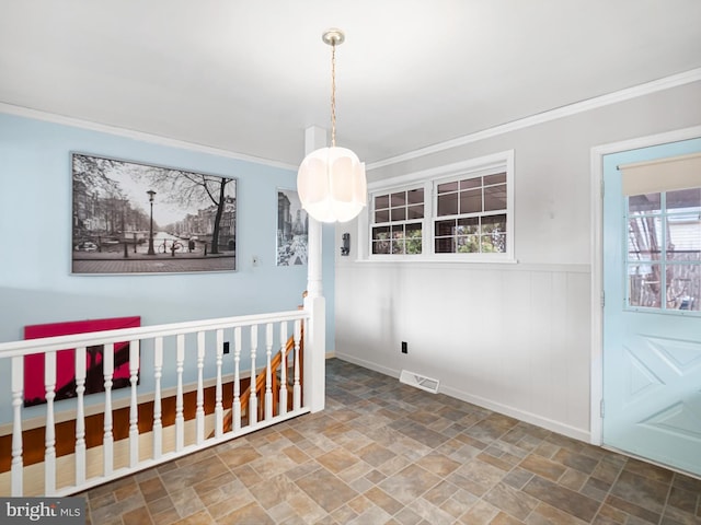 unfurnished dining area featuring crown molding