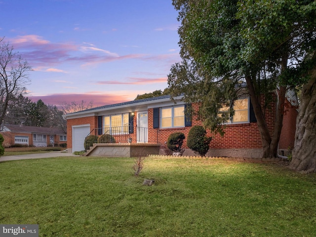 ranch-style house featuring covered porch and a yard