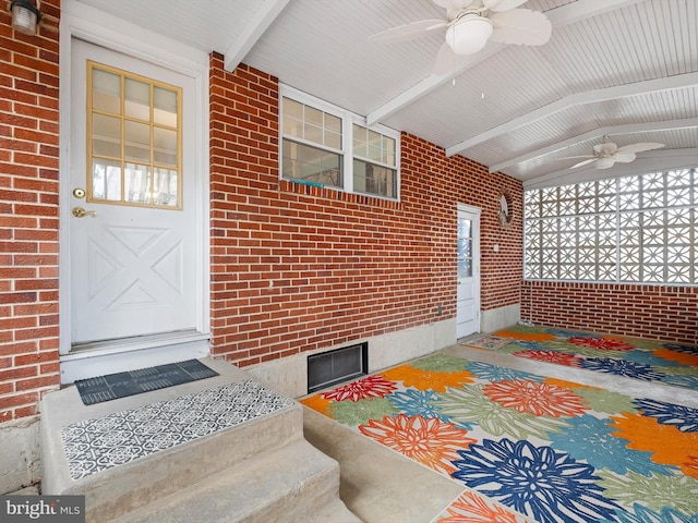 view of exterior entry with covered porch and ceiling fan