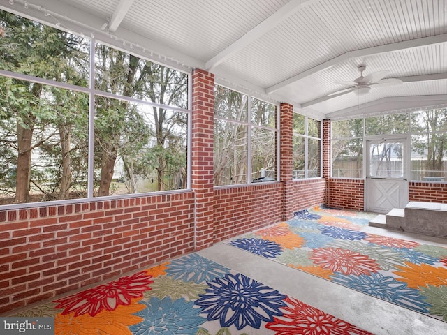 sunroom / solarium featuring ceiling fan and vaulted ceiling