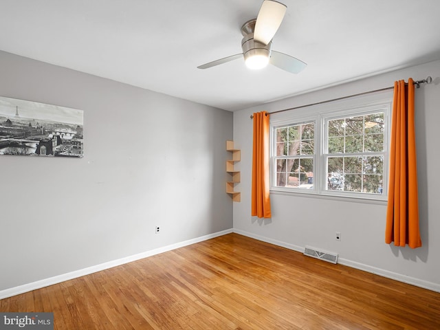 spare room with light hardwood / wood-style flooring and ceiling fan