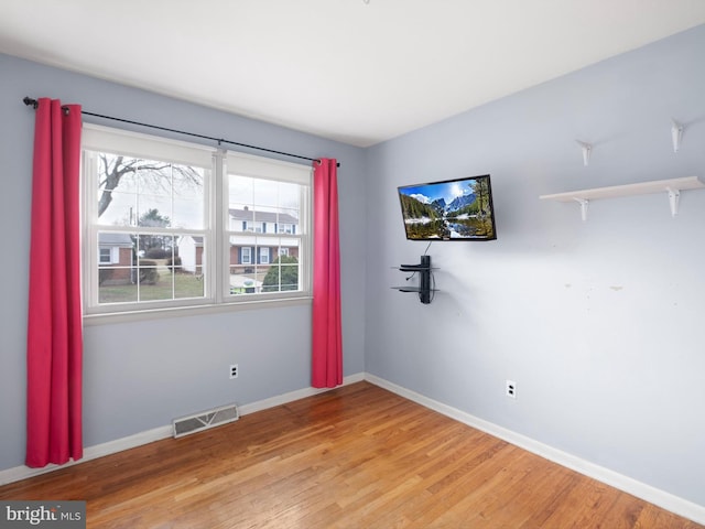 empty room with light hardwood / wood-style floors