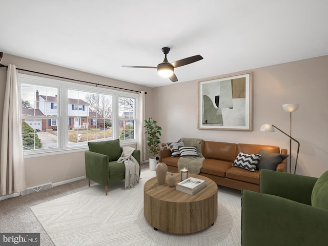 carpeted living room with ceiling fan