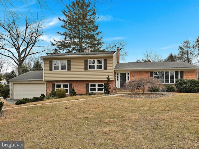 split level home with a garage and a front yard