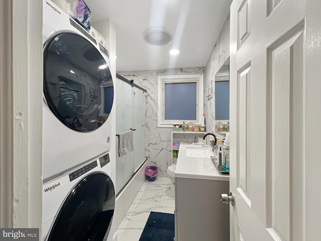 clothes washing area with sink and stacked washer and clothes dryer