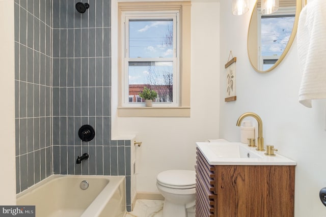 full bathroom featuring vanity, tiled shower / bath combo, and toilet