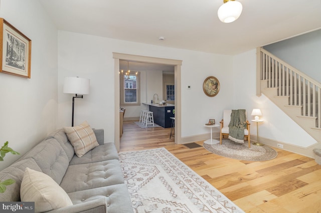 living room featuring hardwood / wood-style floors and sink