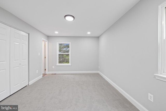 unfurnished bedroom featuring light colored carpet