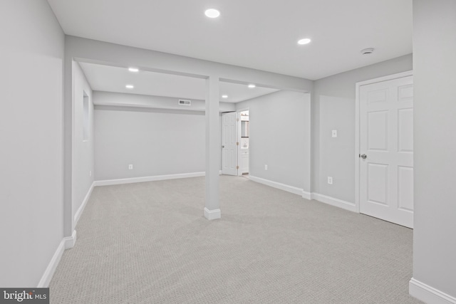 basement featuring light colored carpet