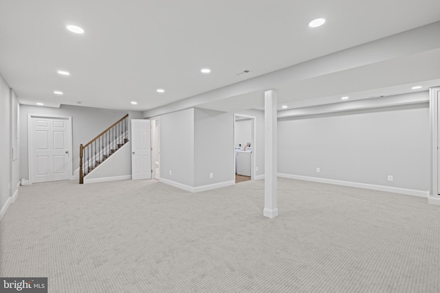 basement featuring light colored carpet