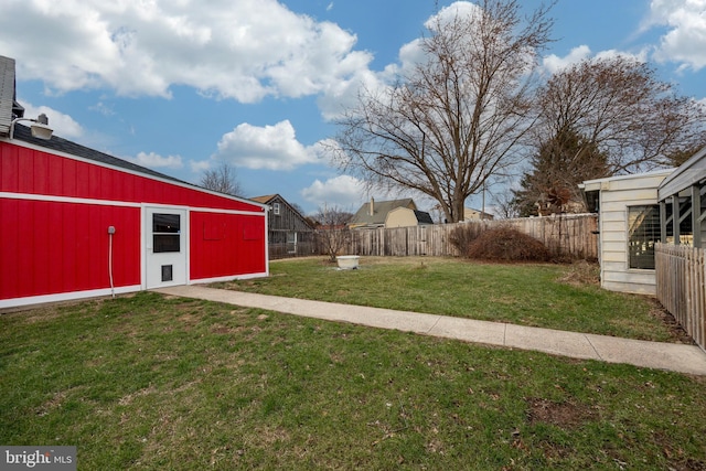 view of yard with an outbuilding and fence