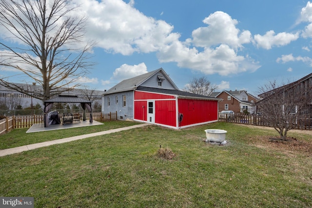 view of yard with a gazebo, a patio, an outdoor structure, and a fenced backyard