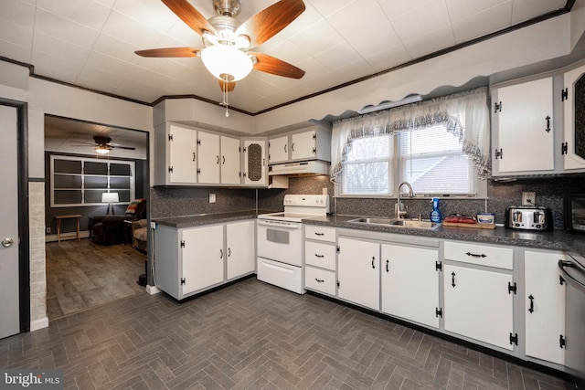 kitchen with white range with electric cooktop, a sink, under cabinet range hood, dark countertops, and backsplash