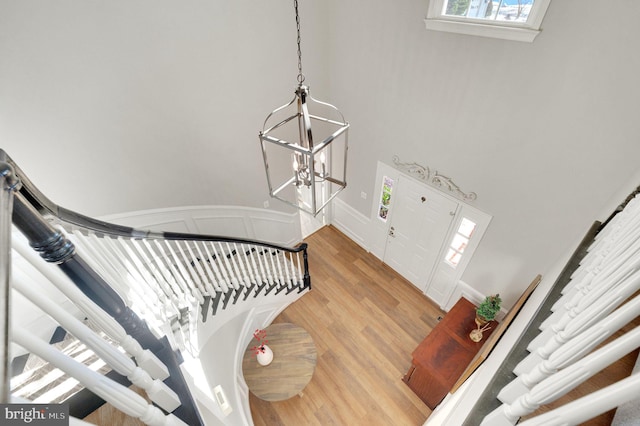 entrance foyer featuring wood-type flooring and a chandelier