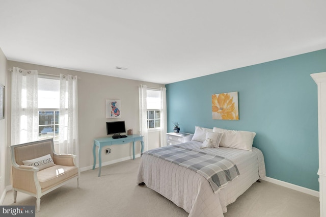 carpeted bedroom featuring multiple windows