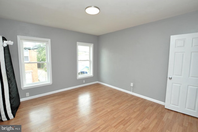 unfurnished room with light hardwood / wood-style flooring