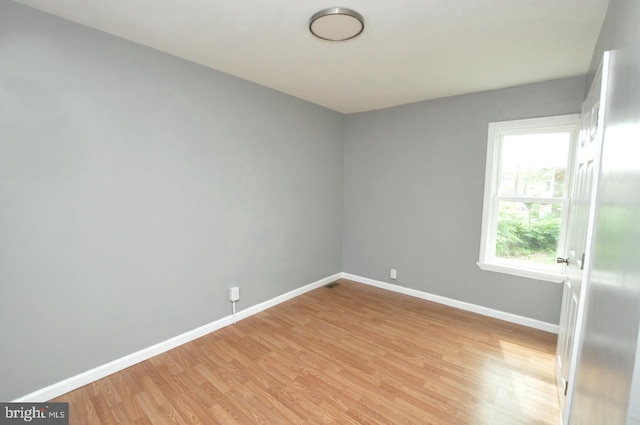 empty room with light hardwood / wood-style floors