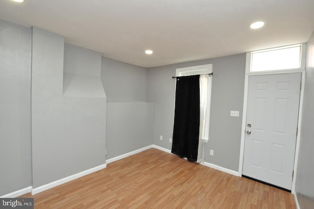 interior space with light wood-type flooring, baseboards, and recessed lighting