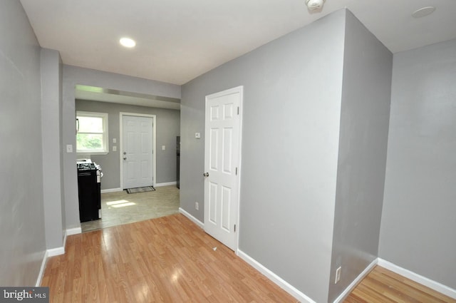 corridor with light hardwood / wood-style floors