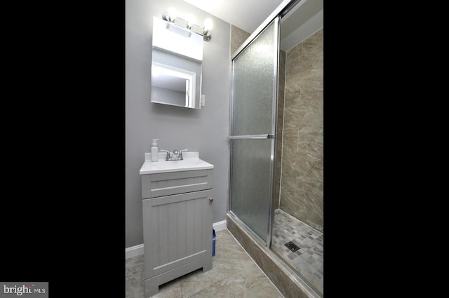 bathroom featuring tile patterned flooring, vanity, and a shower with shower door