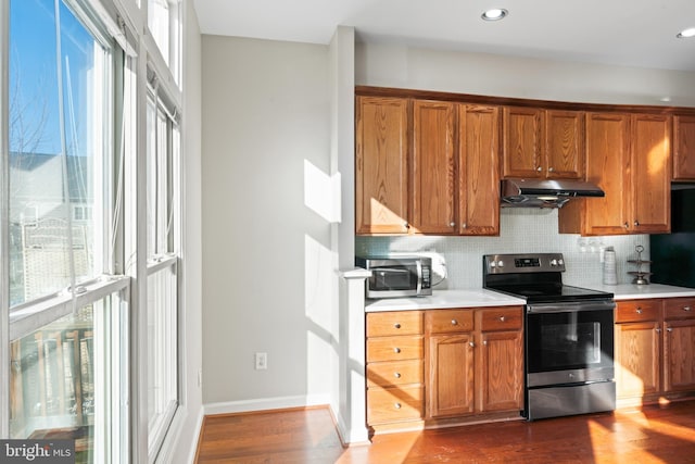 kitchen featuring stainless steel appliances, tasteful backsplash, and dark hardwood / wood-style floors