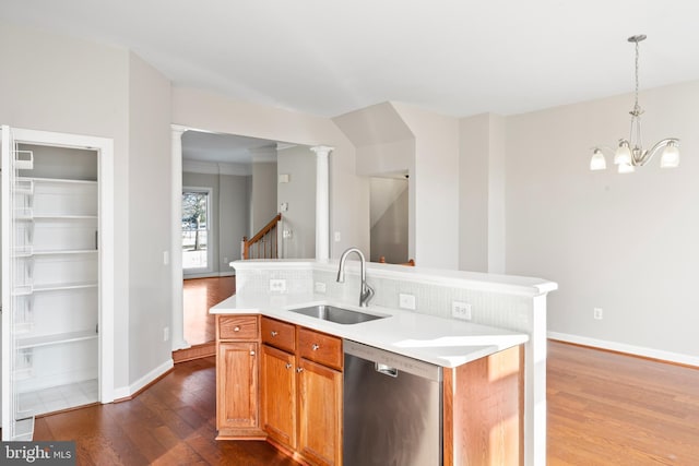 kitchen with stainless steel dishwasher, a kitchen island, a chandelier, and sink