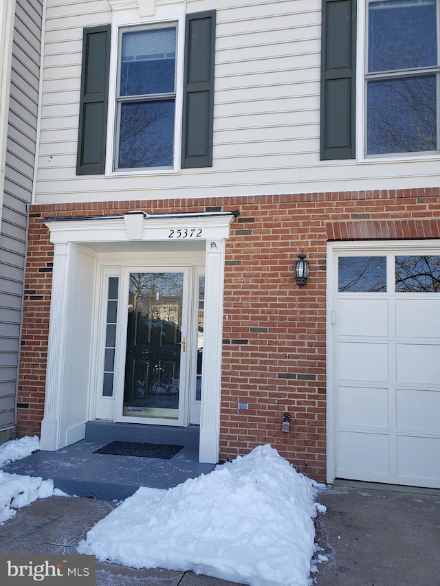 view of snow covered property entrance