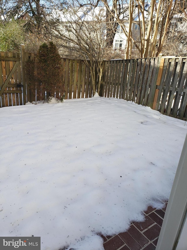 view of yard layered in snow