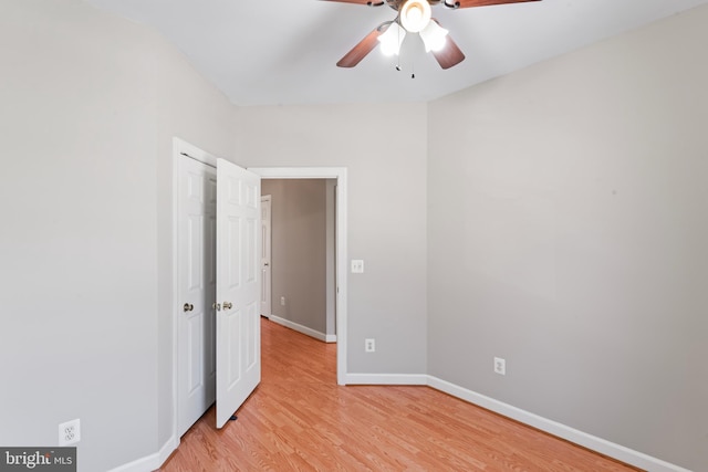 unfurnished bedroom with ceiling fan and light hardwood / wood-style flooring