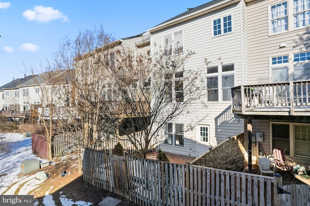 snow covered property with a balcony