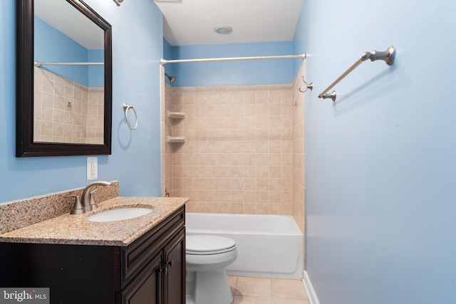 full bathroom featuring vanity, tiled shower / bath, tile patterned floors, and toilet