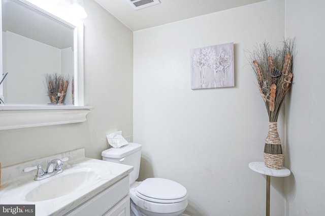 bathroom with toilet and vanity