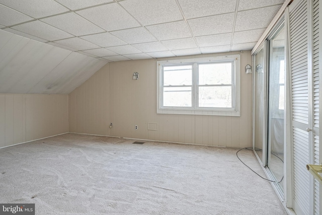 bonus room featuring lofted ceiling and light colored carpet