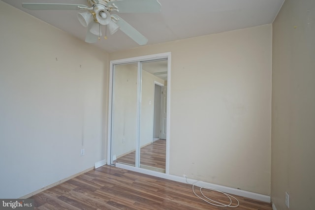 spare room with ceiling fan and wood-type flooring