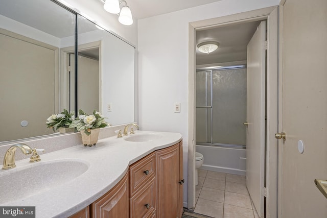 full bathroom featuring toilet, tile patterned flooring, enclosed tub / shower combo, and vanity