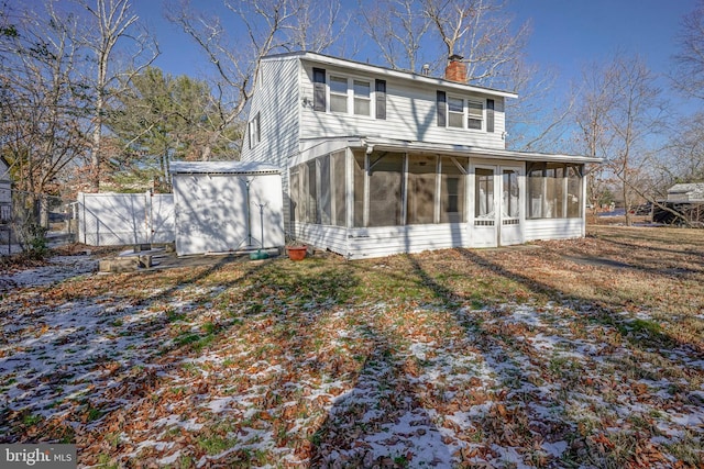 rear view of house featuring a sunroom