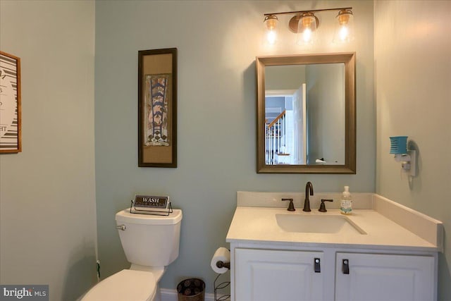 bathroom featuring vanity and toilet