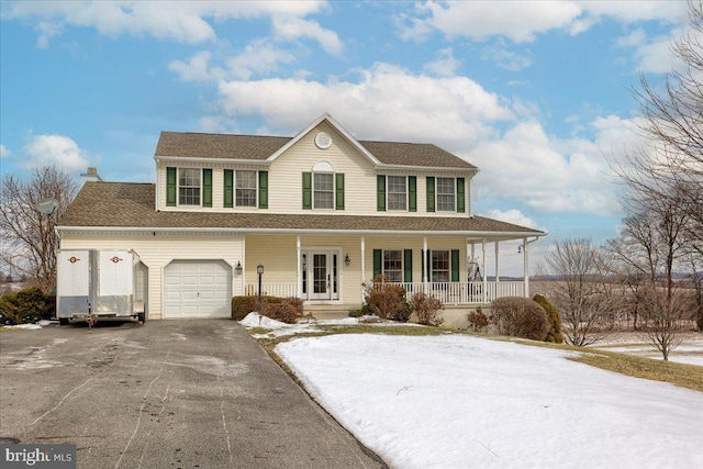 view of front facade featuring covered porch and a garage