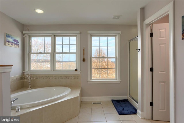 bathroom featuring separate shower and tub, tile patterned floors, and a healthy amount of sunlight