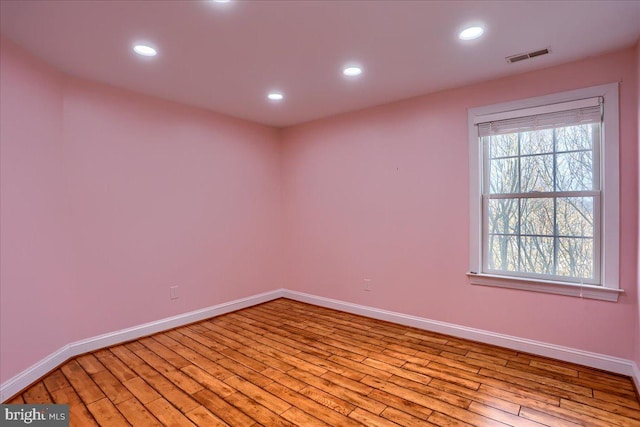 empty room with light hardwood / wood-style flooring