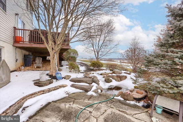 yard layered in snow featuring a wooden deck