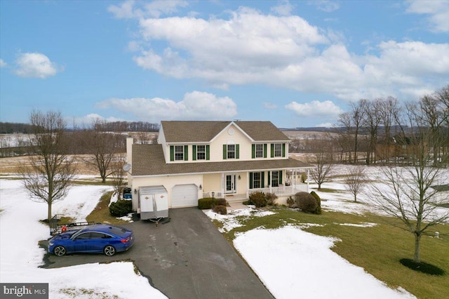 view of front of property featuring a porch and a garage