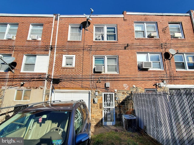 back of property featuring central AC and cooling unit