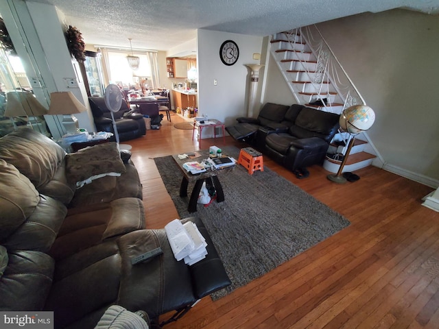 living room featuring hardwood / wood-style floors and a textured ceiling